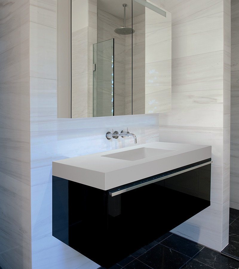 Inspiration for a mid-sized contemporary master bathroom in Philadelphia with an integrated sink, flat-panel cabinets, dark wood cabinets, solid surface benchtops, an open shower, a wall-mount toilet, gray tile, stone tile, grey walls and marble floors.