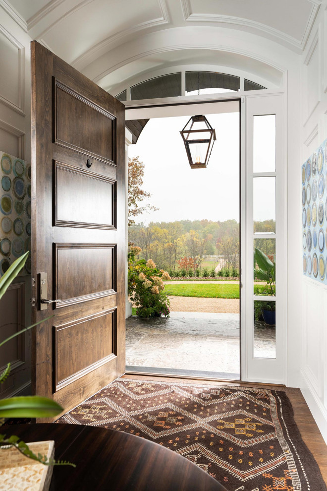 Design ideas for a mid-sized traditional front door in Other with white walls, medium hardwood floors, a medium wood front door, brown floor and panelled walls.