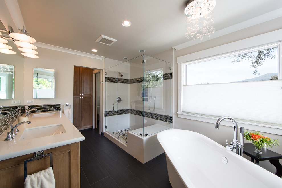 Photo of a mid-sized contemporary master bathroom in San Francisco with a pedestal sink, recessed-panel cabinets, medium wood cabinets, granite benchtops, a freestanding tub, a double shower, a two-piece toilet, white tile, porcelain tile, beige walls and porcelain floors.