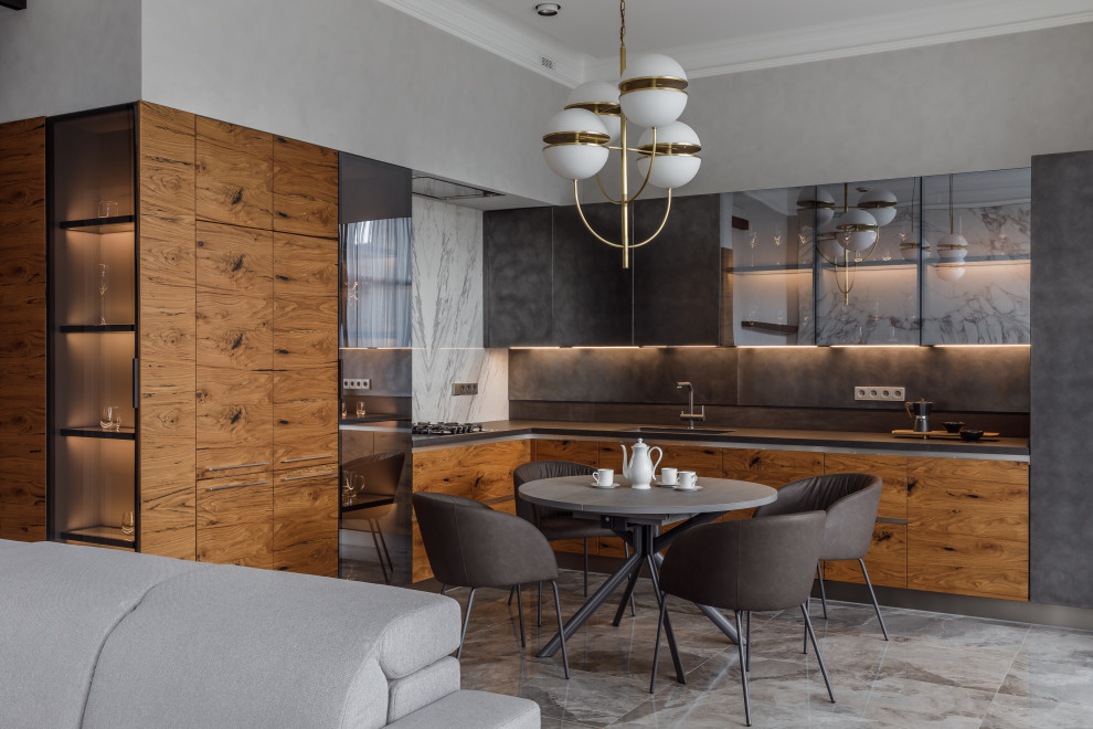 Contemporary l-shaped kitchen/diner in Other with glass-front cabinets, medium wood cabinets, grey splashback, black appliances and grey worktops.