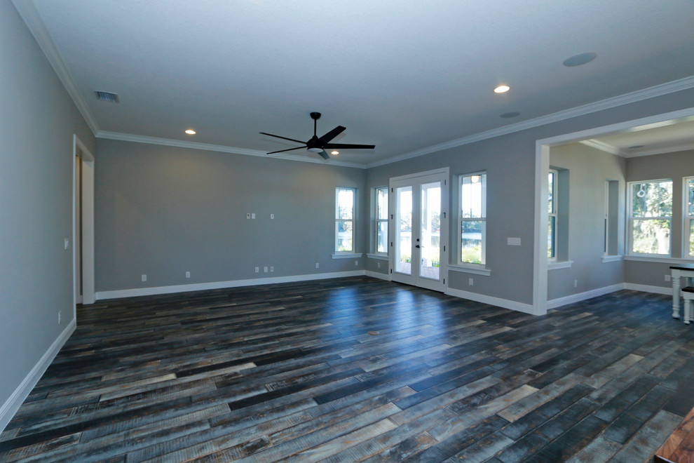 Photo of an expansive country open concept family room in Orlando with dark hardwood floors and no fireplace.