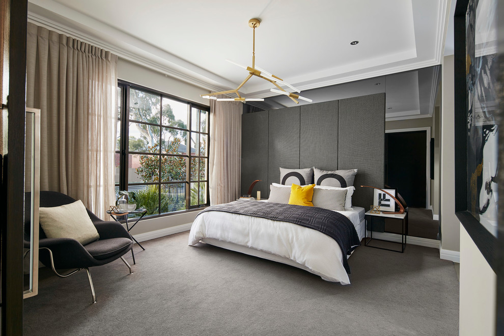 This is an example of a large contemporary bedroom in Melbourne with carpet and beige walls.