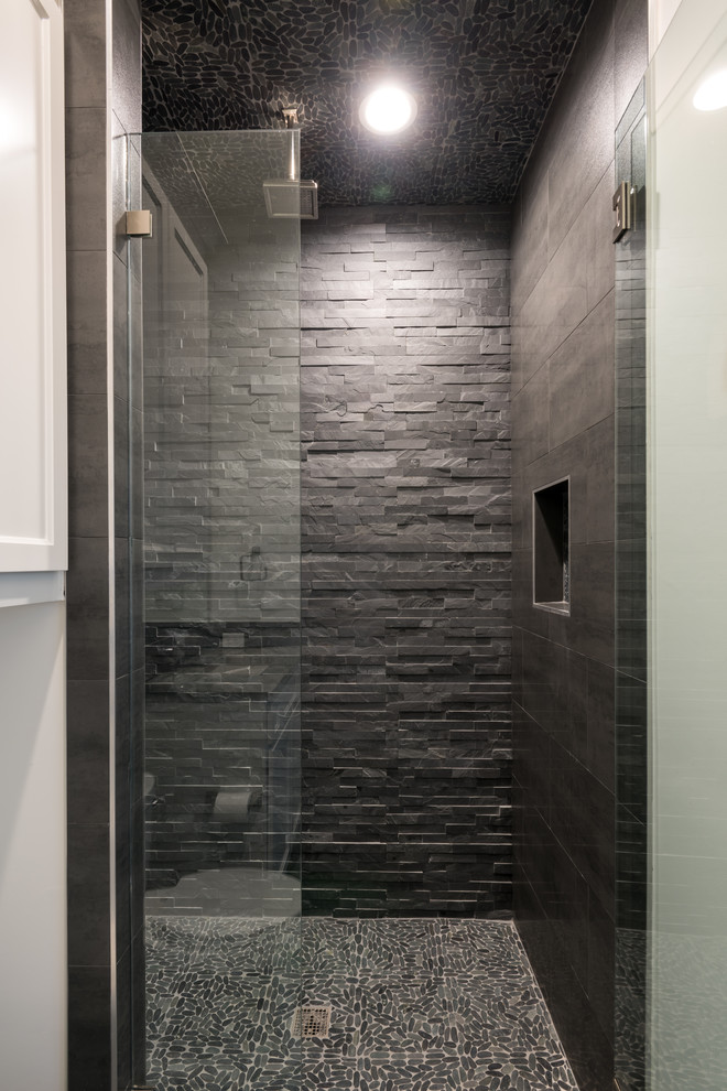 This is an example of an expansive transitional kids bathroom in Dallas with grey cabinets, an alcove shower, a one-piece toilet, gray tile, porcelain tile, black walls, porcelain floors, an undermount sink, concrete benchtops, grey floor, a hinged shower door and shaker cabinets.