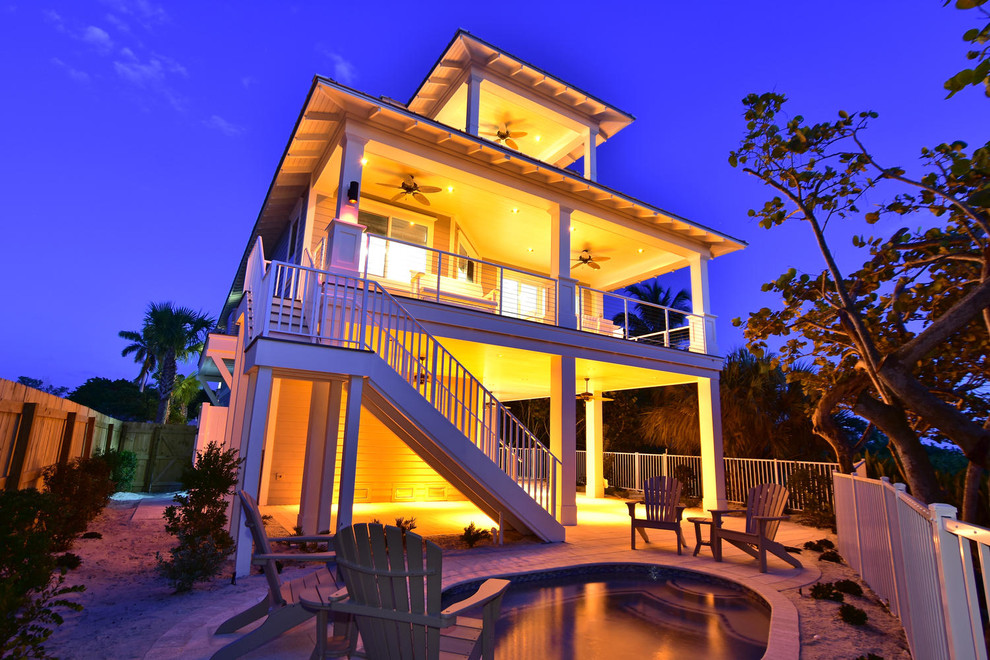 Large beach style two-storey blue exterior in Tampa with wood siding.