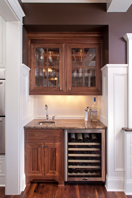 Inspiration for a small traditional single-wall wet bar in Minneapolis with beaded inset cabinets, dark wood cabinets, granite benchtops and dark hardwood floors.
