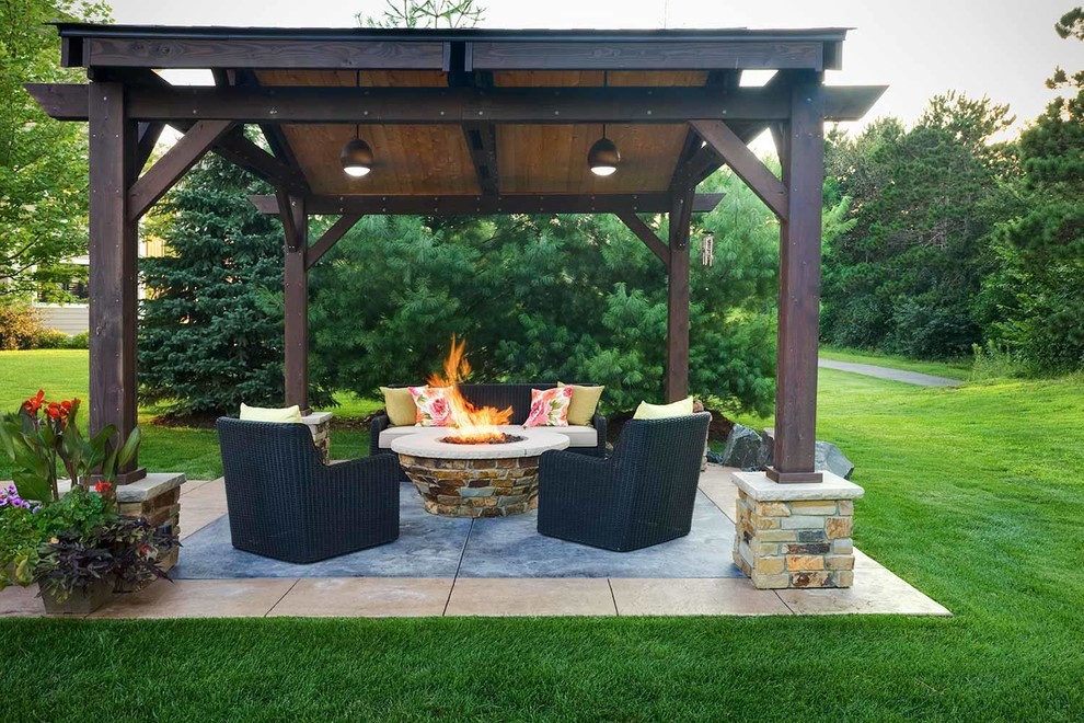Inspiration for a mid-sized backyard patio in Minneapolis with with fireplace and concrete pavers.