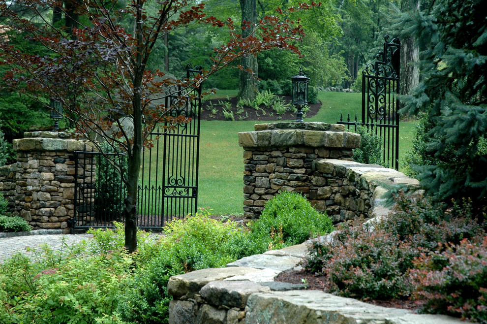 Design ideas for a large traditional front yard stone driveway in New York.