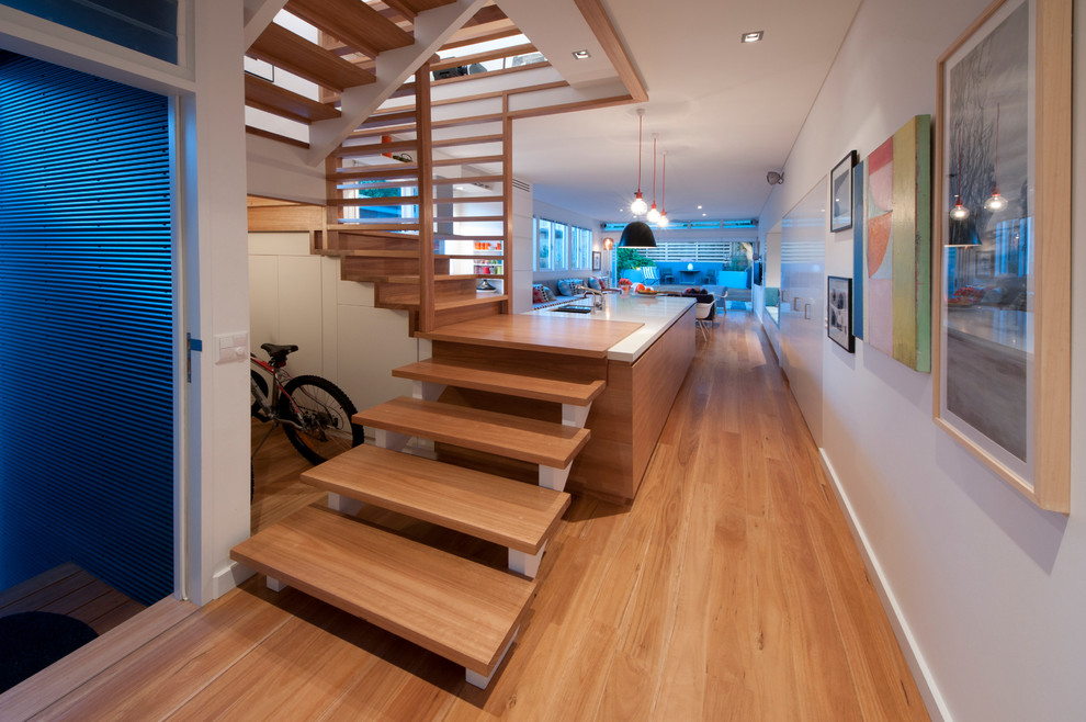 This is an example of a contemporary wood floating staircase in Sydney with open risers.
