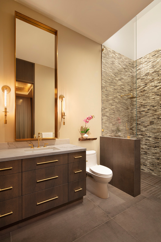 Inspiration for a small contemporary 3/4 bathroom in San Francisco with flat-panel cabinets, a curbless shower, a one-piece toilet, green tile, glass tile, beige walls, porcelain floors, an undermount sink, marble benchtops, grey floor, an open shower, white benchtops, a single vanity, a built-in vanity and dark wood cabinets.