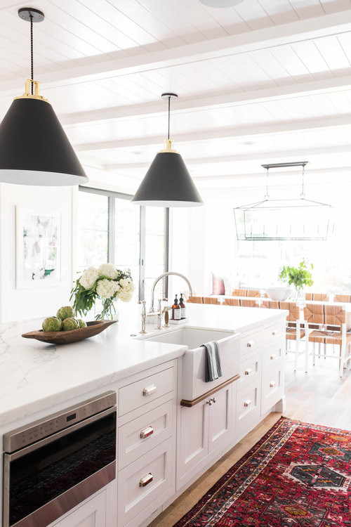 Photo of a large beach style eat-in kitchen in Salt Lake City with a farmhouse sink, white cabinets, white splashback, stainless steel appliances, medium hardwood floors and with island.