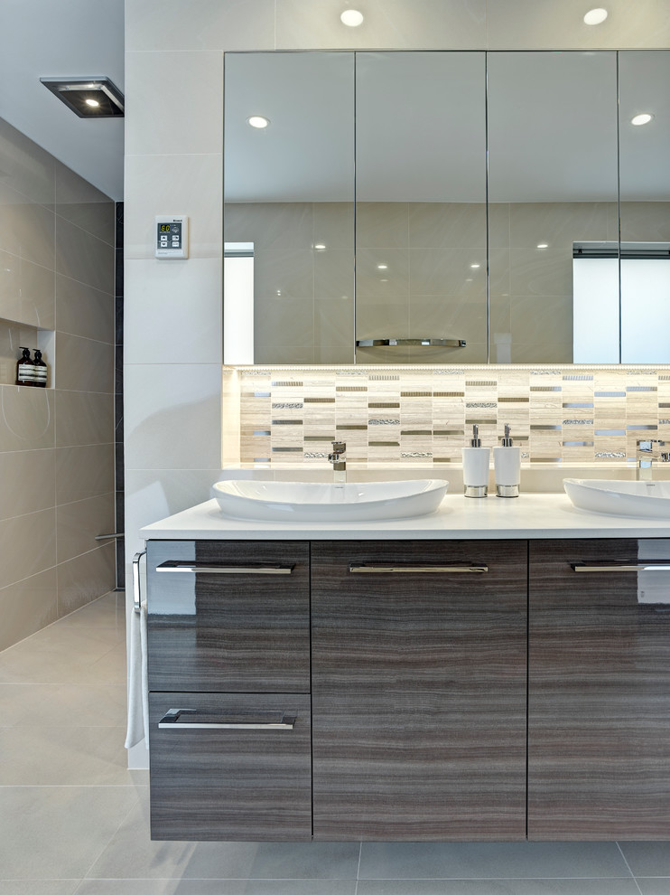 Photo of a large contemporary master bathroom in Other with a vessel sink, dark wood cabinets, a freestanding tub, an open shower, beige tile, porcelain tile, beige walls and porcelain floors.