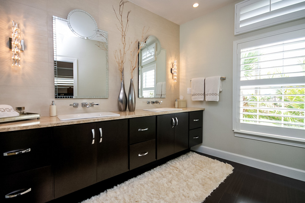 Design ideas for a contemporary bathroom in Jacksonville with a drop-in sink, flat-panel cabinets, dark wood cabinets, beige tile and dark hardwood floors.