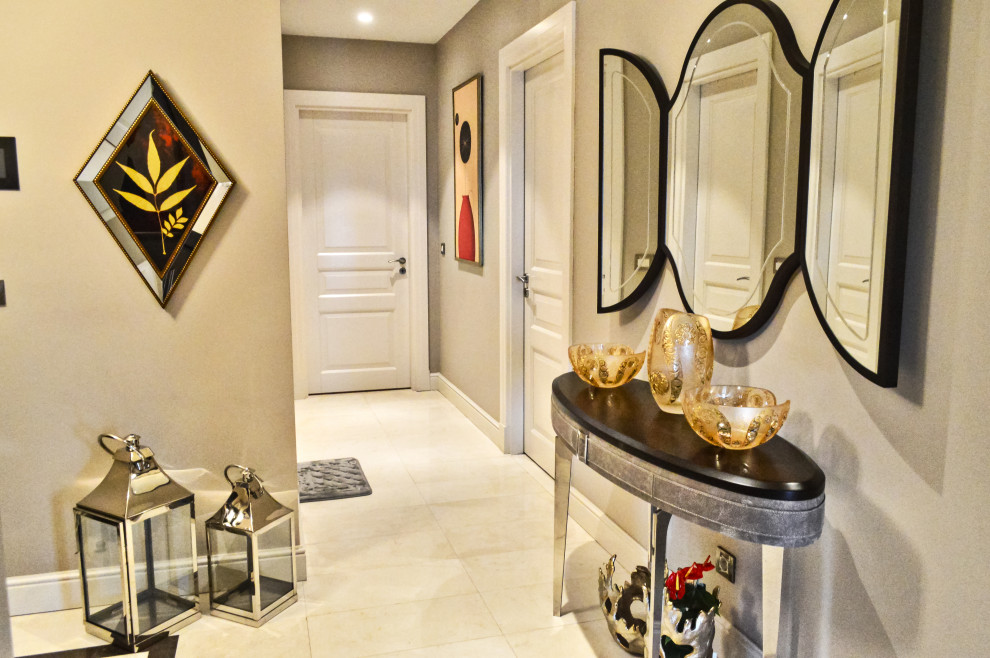 This is an example of a mid-sized modern foyer in Other with beige walls, travertine floors and beige floor.