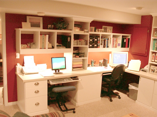 Photo of a large traditional home office in Chicago with red walls, a built-in desk, carpet, no fireplace and beige floor.