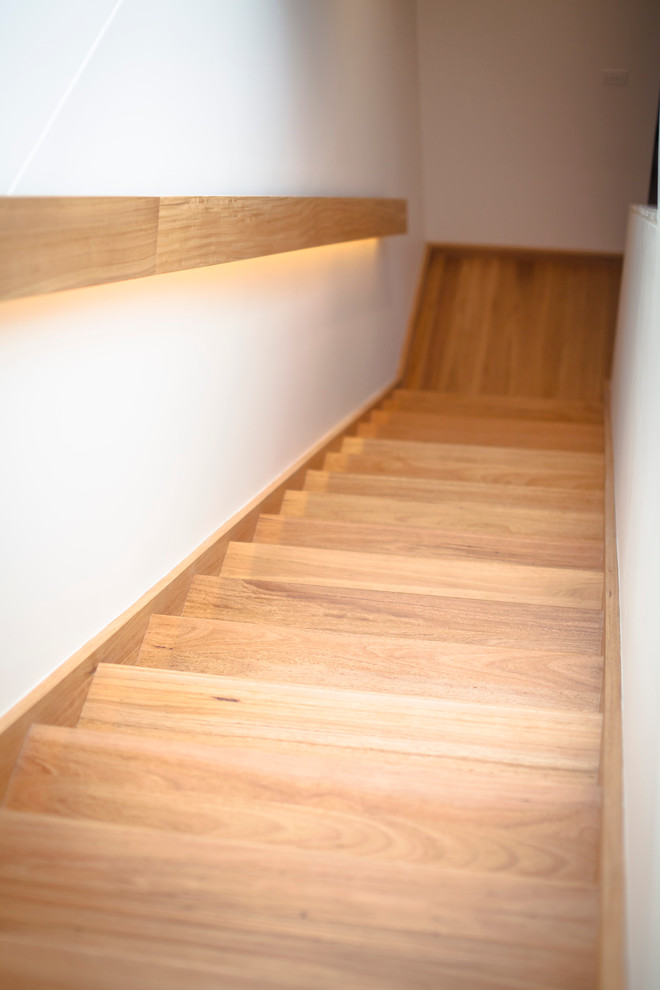 Inspiration for a large contemporary wood l-shaped staircase in Melbourne with wood risers.