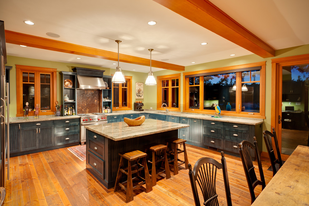 Traditional u-shaped eat-in kitchen in Vancouver with recessed-panel cabinets and blue cabinets.