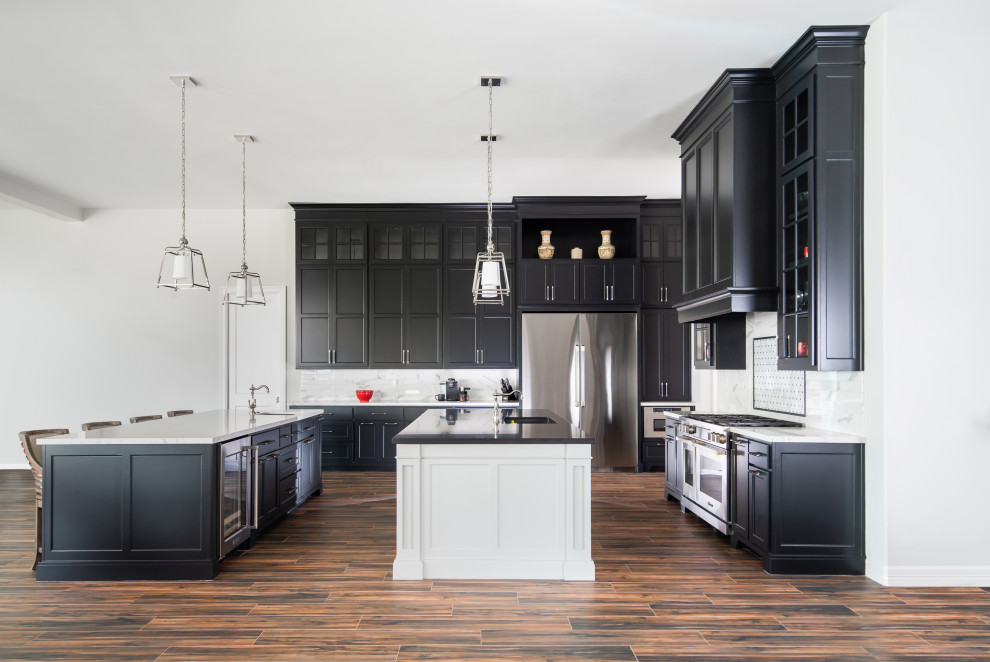 This is an example of a mid-sized transitional l-shaped kitchen in Houston with white splashback, marble splashback, porcelain floors, brown floor, shaker cabinets, black cabinets, quartz benchtops, stainless steel appliances, multiple islands, an undermount sink and multi-coloured benchtop.