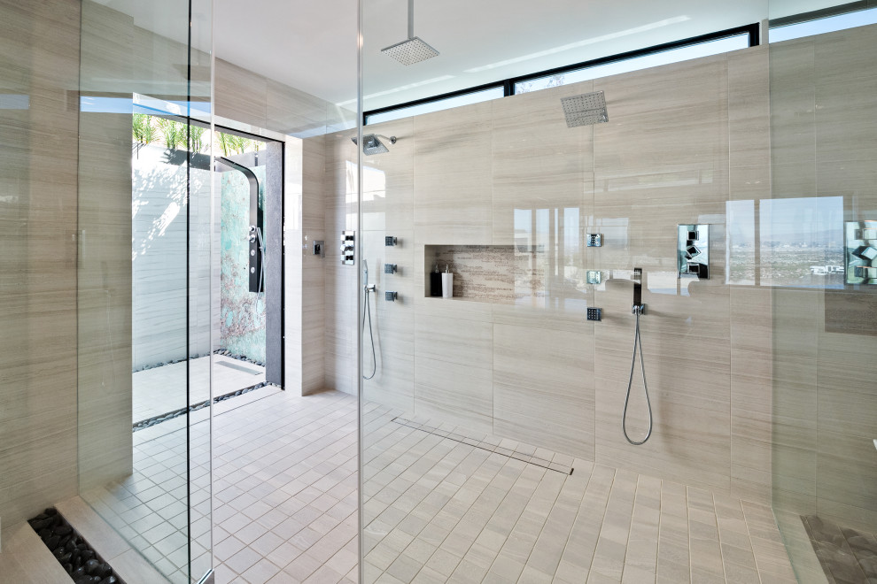 Expansive contemporary ensuite bathroom in Las Vegas with a double shower, beige floors and a hinged door.