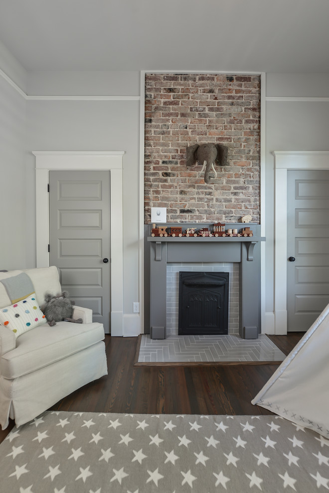 Photo of a mid-sized transitional bedroom in Atlanta with medium hardwood floors, a standard fireplace and a tile fireplace surround.