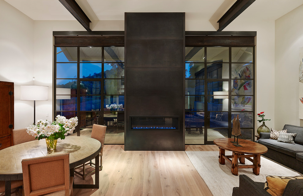 Contemporary formal open concept living room in San Francisco with beige walls, light hardwood floors, a ribbon fireplace, a metal fireplace surround and no tv.