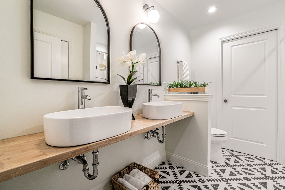Design ideas for a large contemporary 3/4 bathroom in Louisville with a two-piece toilet, white walls, a vessel sink, wood benchtops, multi-coloured floor, beige benchtops, a double vanity and a floating vanity.