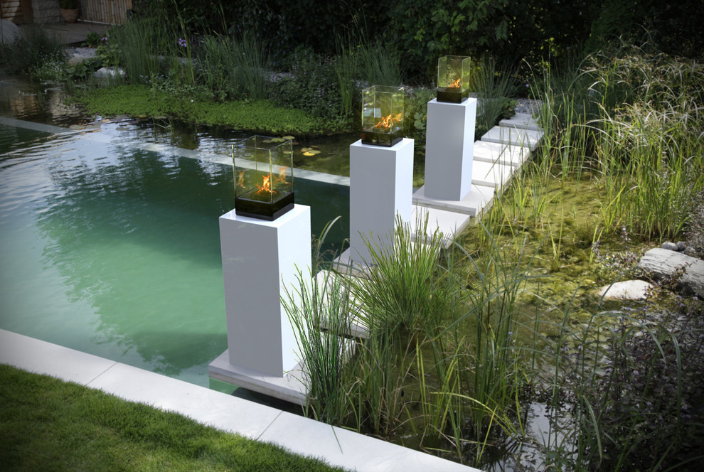 Inspiration for a large contemporary backyard formal garden in Toronto with a fire feature.