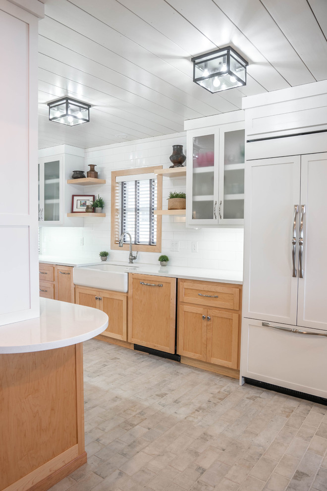 Photo of a scandinavian galley open plan kitchen in Other with a farmhouse sink, shaker cabinets, light wood cabinets, quartz benchtops, white splashback, ceramic splashback, panelled appliances, ceramic floors, with island, white floor and white benchtop.