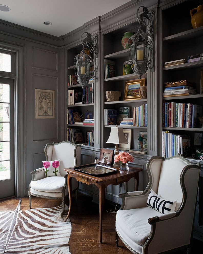 Inspiration for a traditional home office in Kansas City with a library, grey walls and dark hardwood floors.