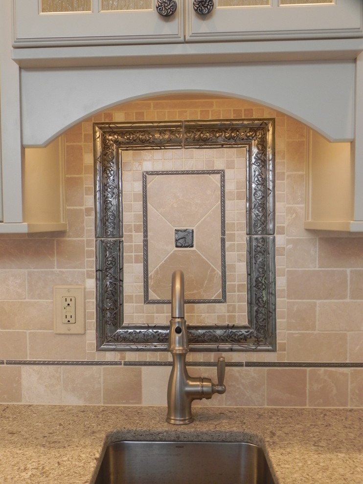 Inspiration for a small transitional single-wall home design remodel with an undermount sink, raised-panel cabinets, white cabinets, granite countertops, beige backsplash and ceramic backsplash