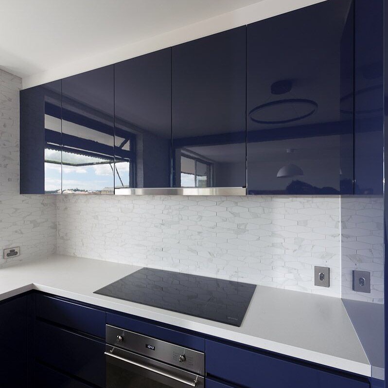 Inspiration for a mid-sized contemporary u-shaped open plan kitchen in Brisbane with an undermount sink, flat-panel cabinets, blue cabinets, quartz benchtops, white splashback, stone tile splashback, stainless steel appliances, porcelain floors and a peninsula.