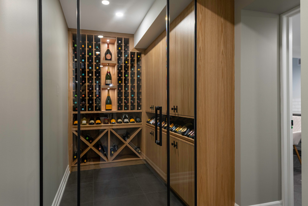 Mid-sized transitional wine cellar in Ottawa with storage racks and grey floor.