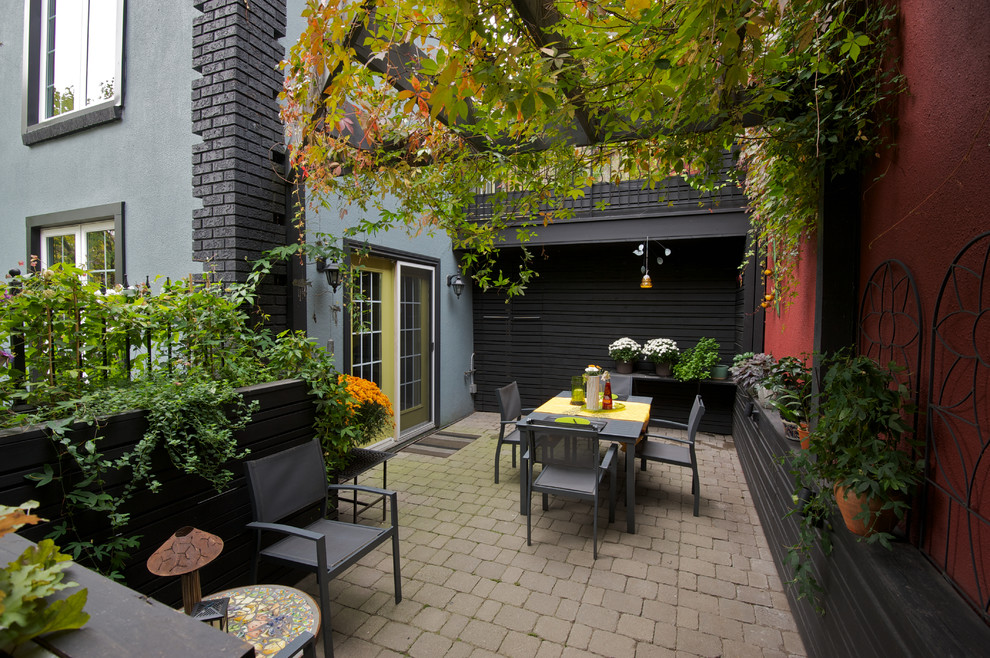 Photo of a contemporary patio in Toronto with concrete pavers and no cover.