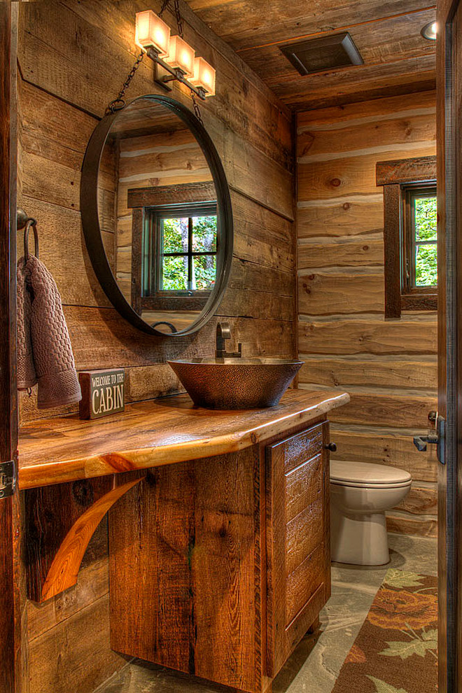 Inspiration for a country powder room in Minneapolis with a vessel sink, medium wood cabinets, wood benchtops and brown benchtops.