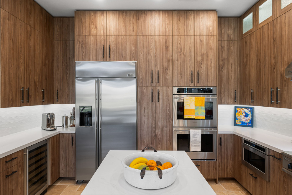 Enclosed kitchen - rustic l-shaped slate floor and beige floor enclosed kitchen idea with a single-bowl sink, flat-panel cabinets, medium tone wood cabinets, quartzite countertops, white backsplash, glass sheet backsplash, stainless steel appliances, a peninsula and white countertops