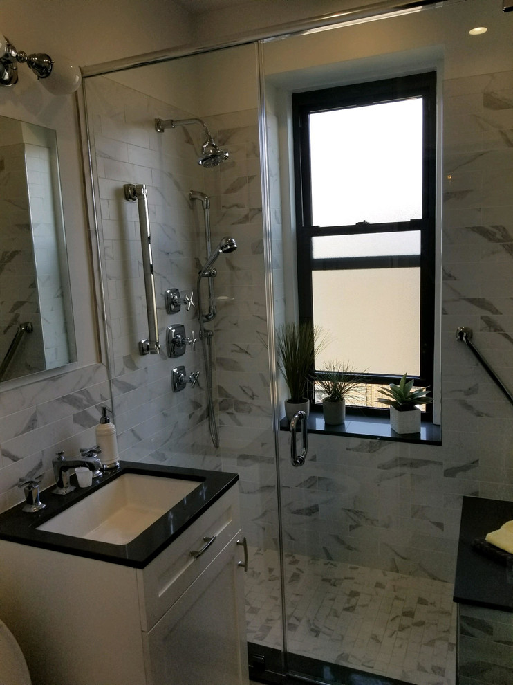 Inspiration for a mid-sized transitional master bathroom in New York with shaker cabinets, white cabinets, a one-piece toilet, ceramic tile, white walls, porcelain floors and an undermount sink.