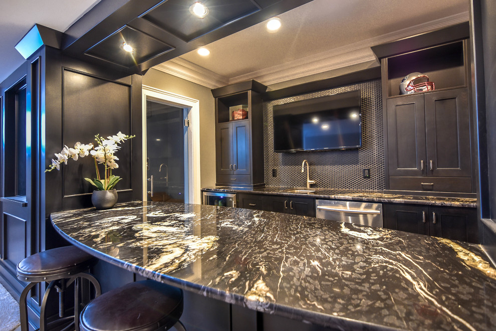 Design ideas for a mid-sized transitional single-wall seated home bar in Edmonton with an undermount sink, shaker cabinets, black cabinets, marble benchtops, black splashback, porcelain floors, beige floor and mosaic tile splashback.