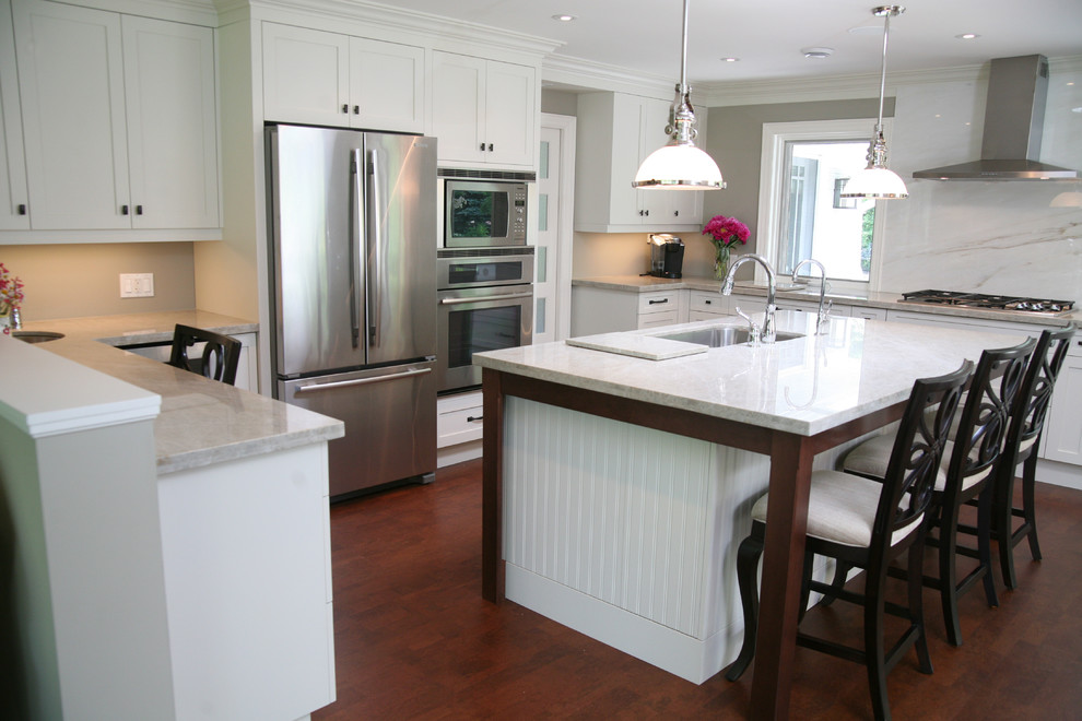 Large transitional l-shaped dark wood floor and brown floor eat-in kitchen photo in Toronto with an undermount sink, shaker cabinets, white cabinets, stainless steel appliances and an island