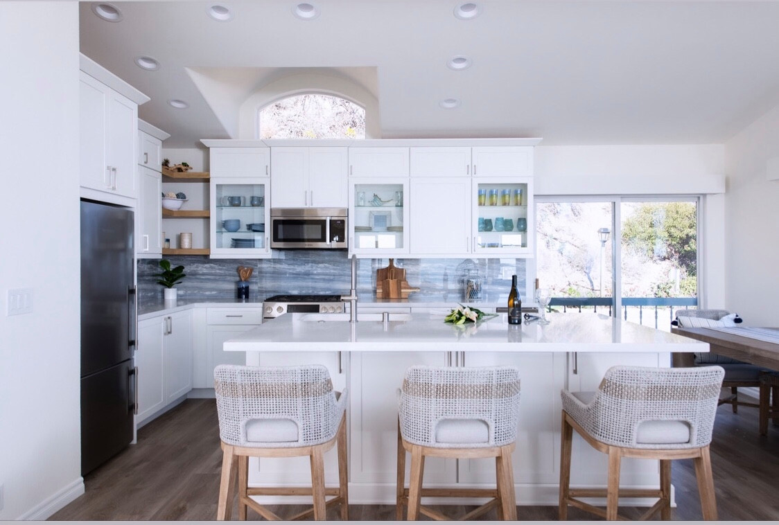 Coastal cottage with ocean blue backsplash and open wood shelves