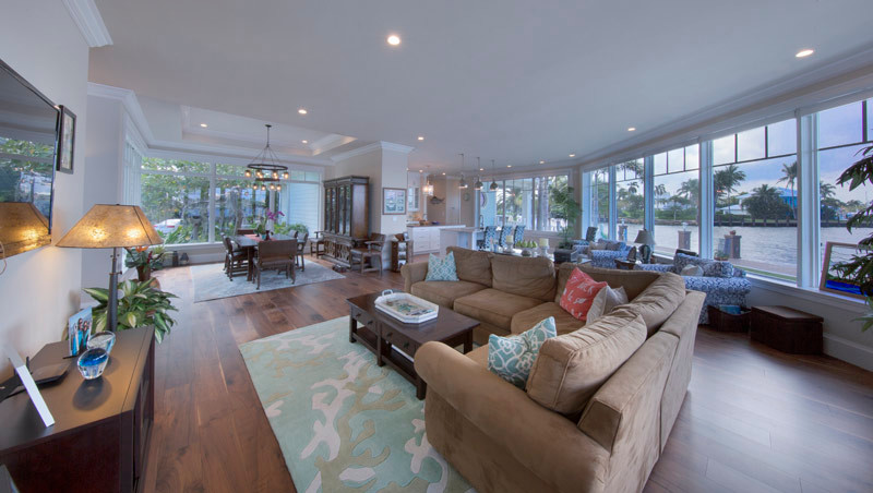 This is an example of an expansive tropical family room in Miami with medium hardwood floors.
