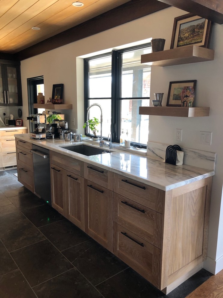 Large transitional u-shaped separate kitchen in Other with an undermount sink, shaker cabinets, light wood cabinets, marble benchtops, white splashback, marble splashback, panelled appliances, porcelain floors, with island, black floor and white benchtop.