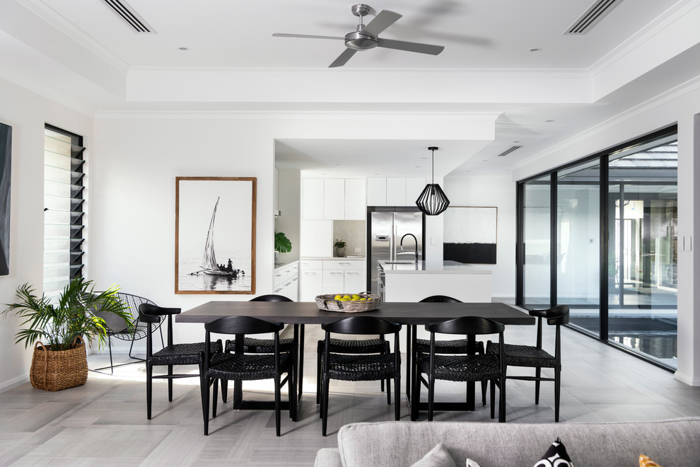 Photo of an expansive contemporary open plan dining in Perth with white walls and grey floor.