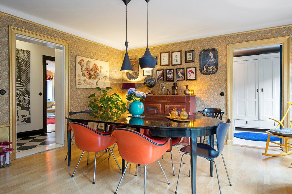 Inspiration for a mid-sized eclectic separate dining room in Stockholm with multi-coloured walls, light hardwood floors and no fireplace.