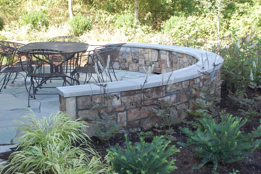 Design ideas for a mid-sized transitional partial sun backyard stone landscaping in DC Metro.