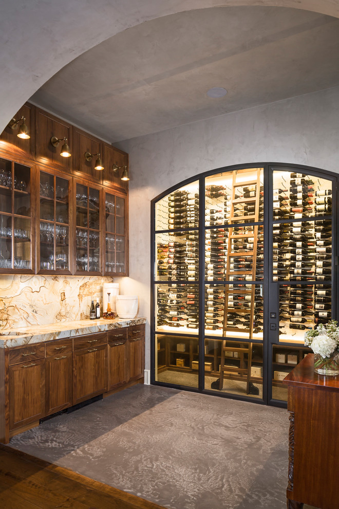Design ideas for a mid-sized transitional wine cellar in Austin with concrete floors, storage racks and grey floor.