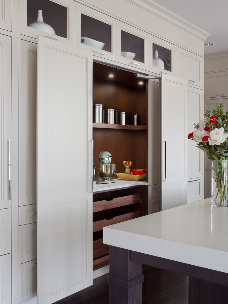 Example of a large transitional u-shaped dark wood floor eat-in kitchen design in Denver with a farmhouse sink, recessed-panel cabinets, beige cabinets, quartz countertops, white backsplash, subway tile backsplash, stainless steel appliances and an island