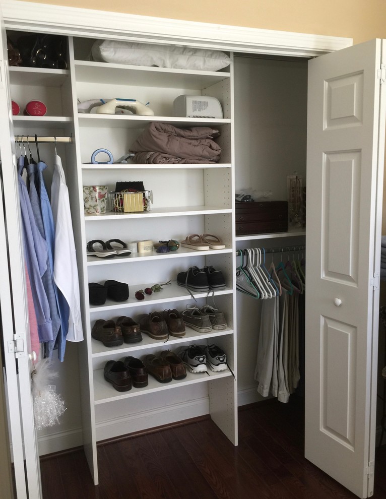 Mid-sized traditional gender-neutral built-in wardrobe in Other with white cabinets, medium hardwood floors and brown floor.