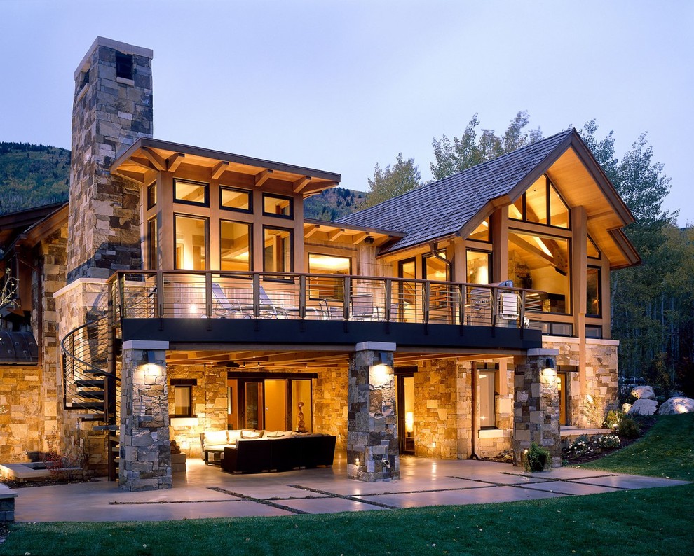 Large rustic brown stone exterior home idea