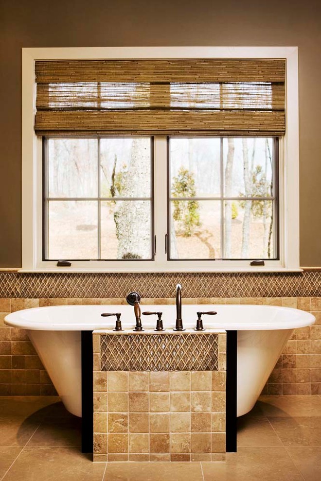 Photo of a mid-sized traditional master bathroom in Charleston with a freestanding tub, brown tile and terra-cotta floors.