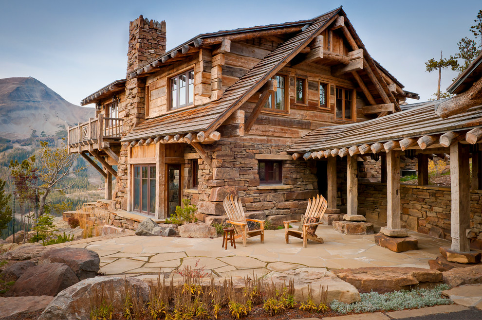 Example of a mountain style stone patio design with no cover