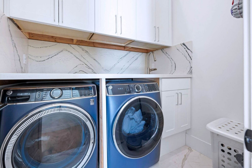 Bright Laundry Room with Marble-Look Backsplash and Built-In Storage